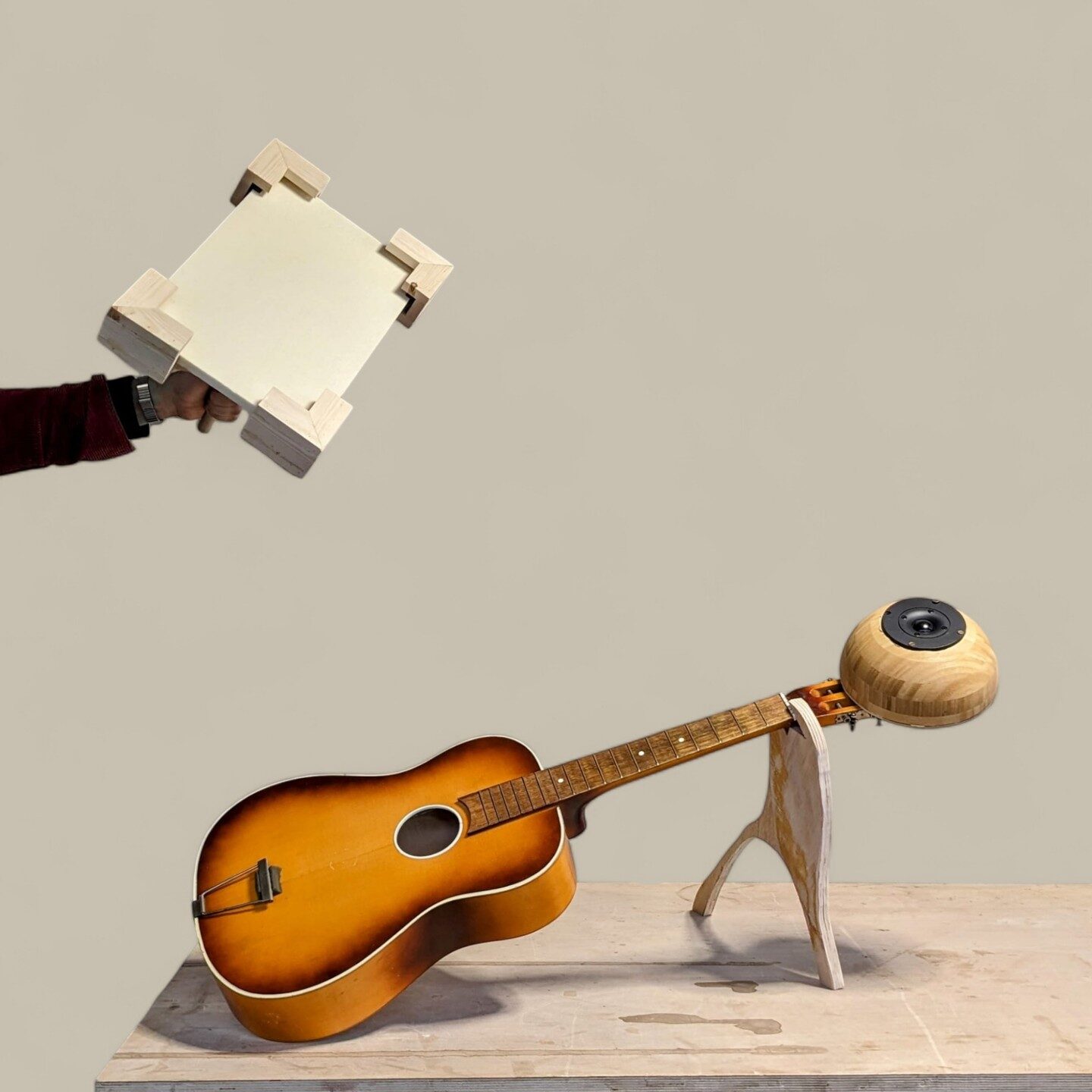 Hero studio shot of a guitar joined to a wooden dome speaker