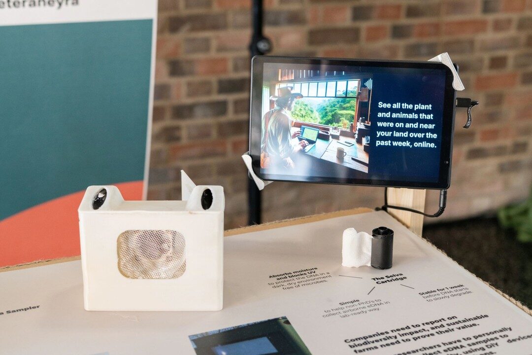 White 3D-printed air sampler prototype beside a tablet at the Terra Carta exhibition
